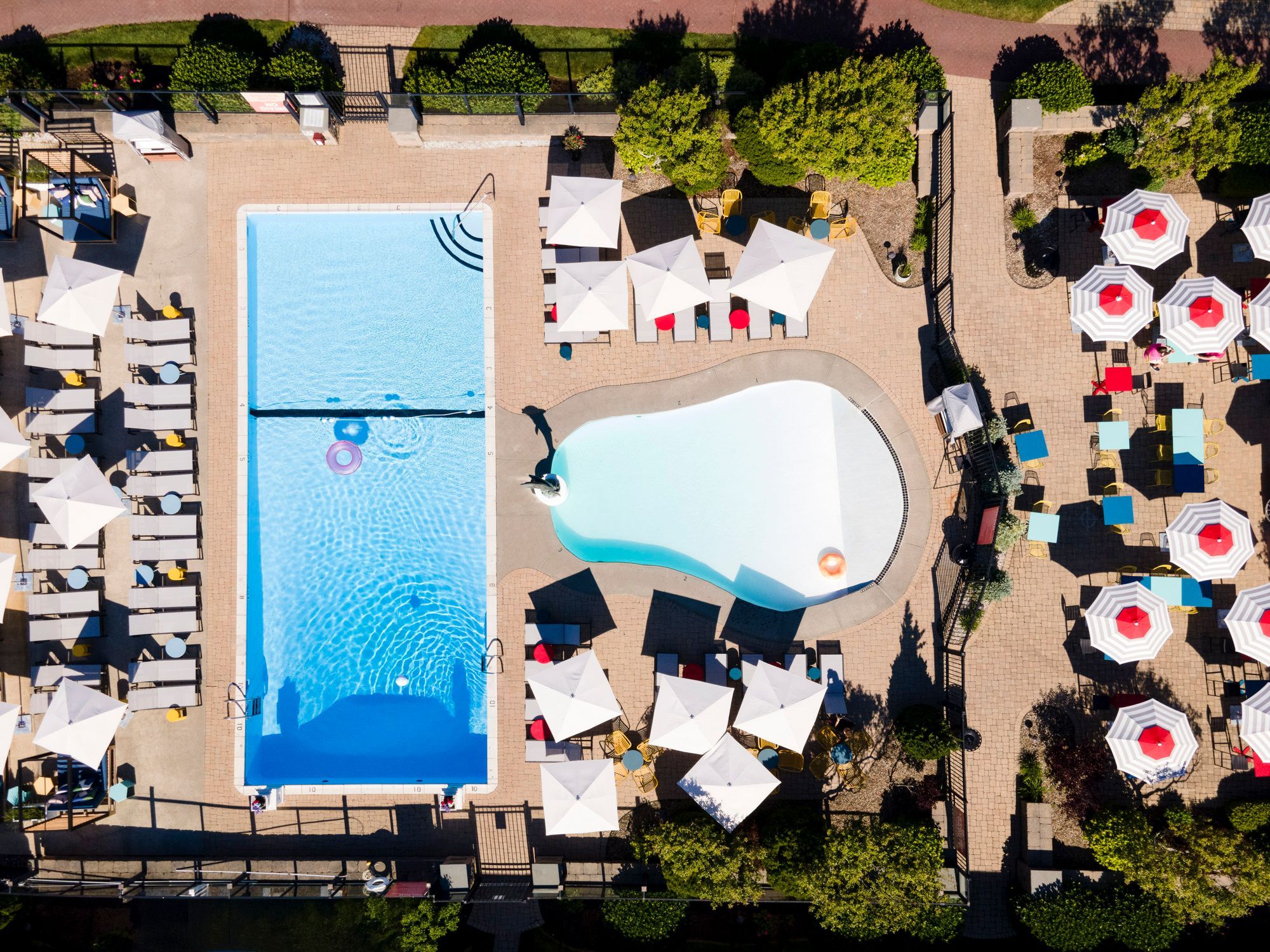 image Bask in summer vibes from above as umbrellas dot the landscape and calm pools invite carefree days.