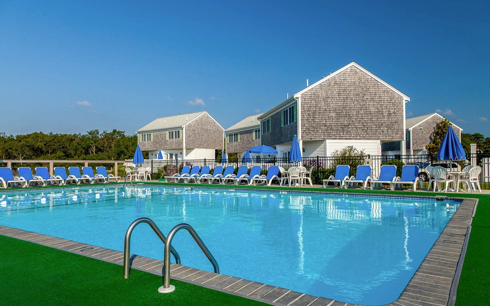 image Dive into vacation mode with a refreshing swim surrounded by classic coastal cottages and blue skies overhead.