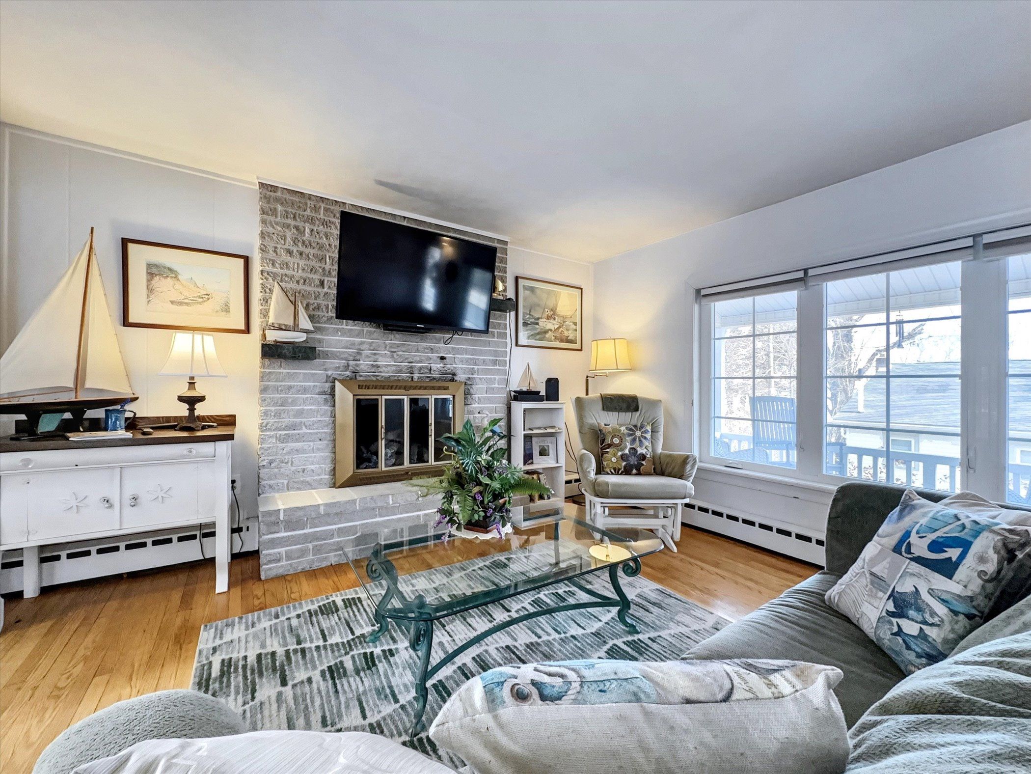 image Cozy and stylish living room featuring a fireplace, plush seating, and a bright, open layout for relaxation.