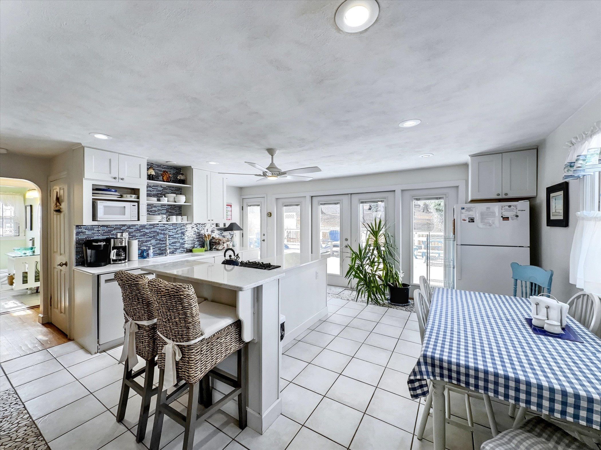 image Bright and airy kitchen and dining space, featuring a charming farmhouse table and plenty of natural light.