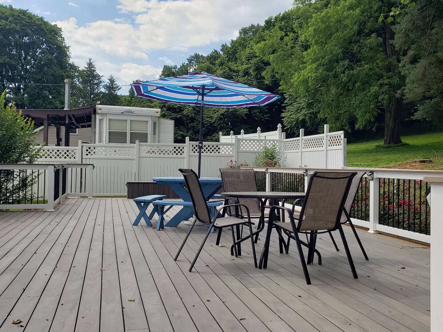 image Spacious private deck with shaded seating and outdoor dining.