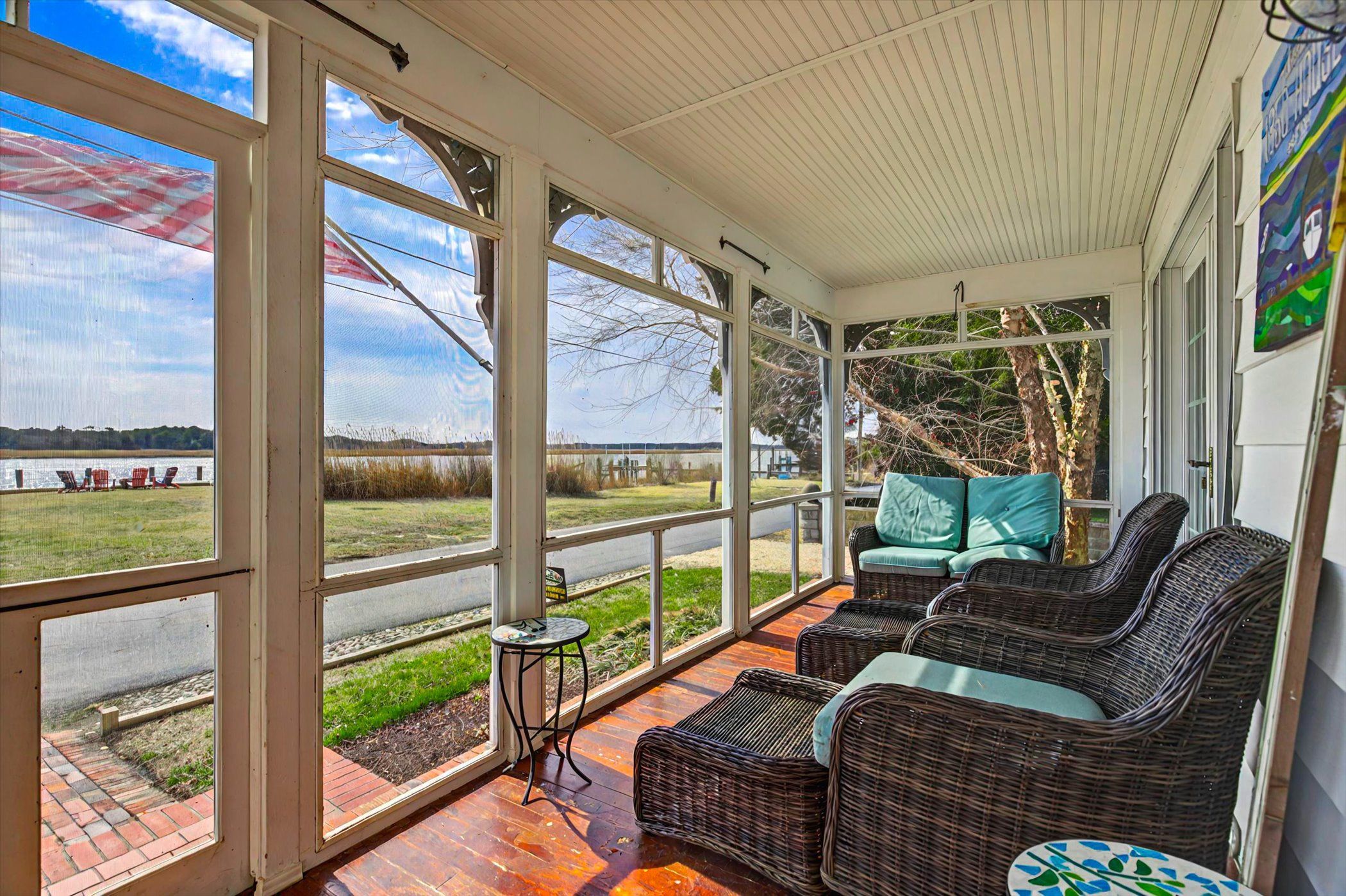 image Relax on the cozy screened-in porch with river views and a gentle breeze.