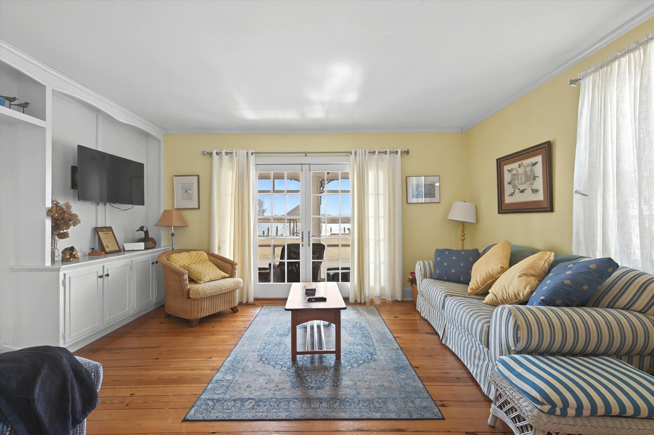 image Bright and cozy living room featuring a Smart TV and comfy seating for family movie nights.