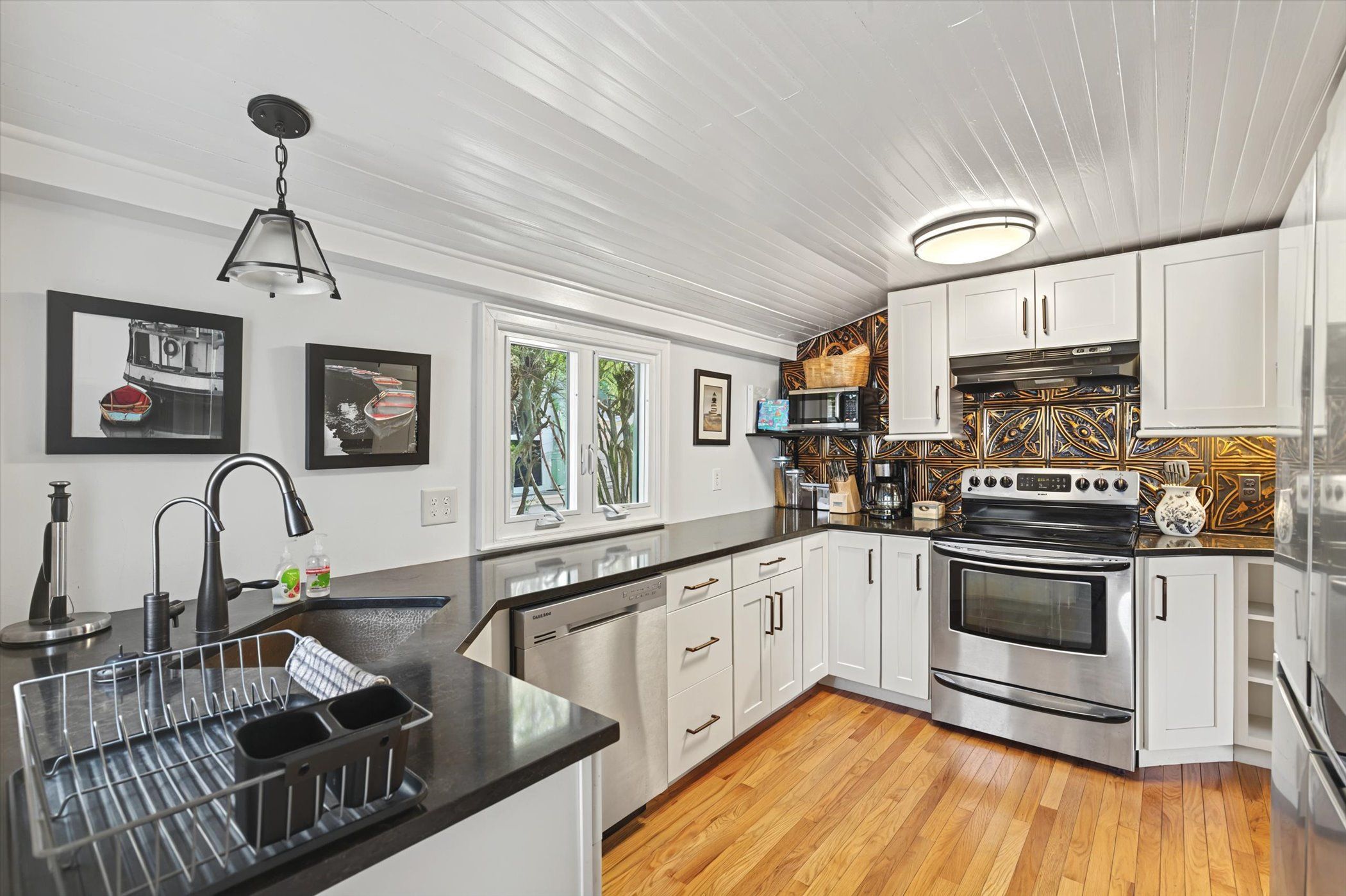 image Stainless steel appliances and farmhouse touches bring both style and function to the kitchen.