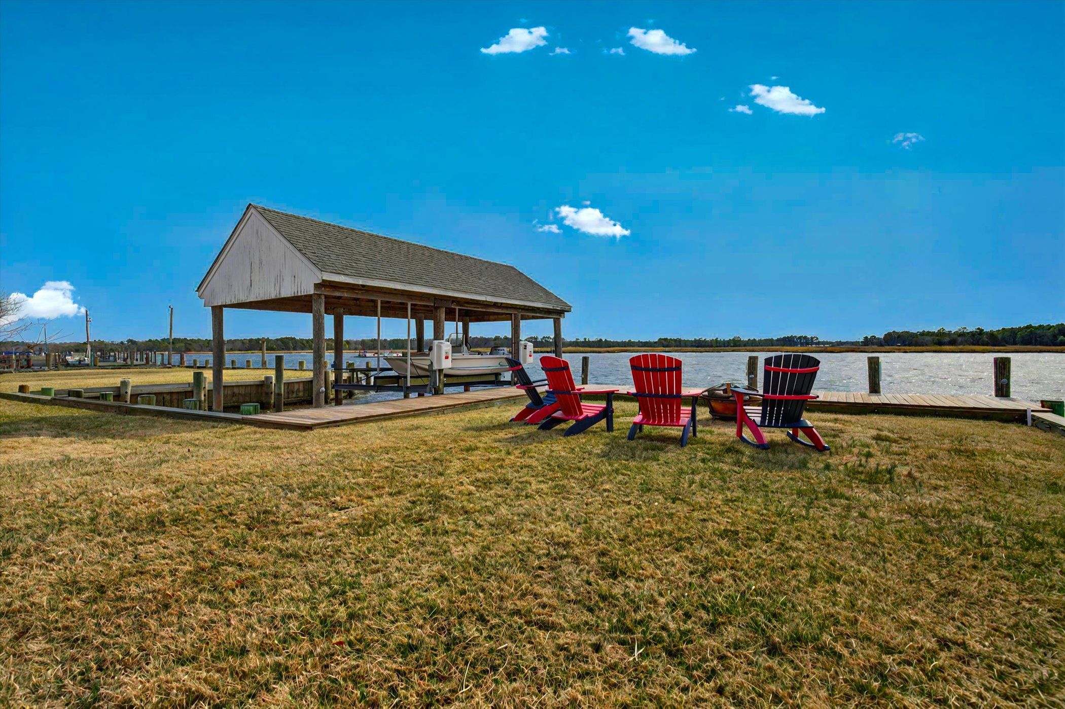 image Relax riverside in Adirondack chairs and take in the view—just steps from your backyard.