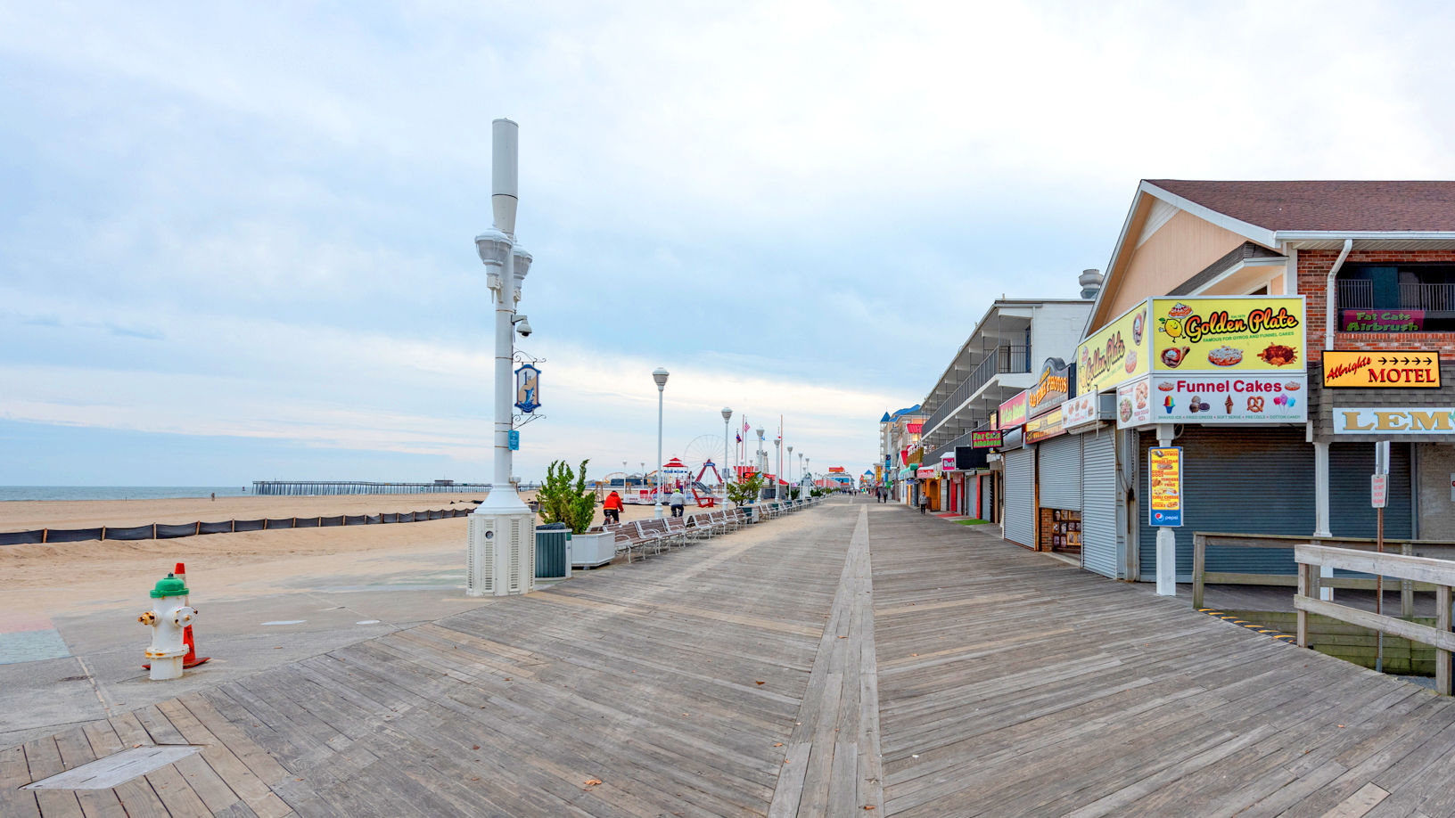 image Experience the vibrant Boardwalk atmosphere just steps from your two Queen Murphy bed studio at Boardwalk One, complete with a full kitchen, balcony views, and direct access to the sandy beach.