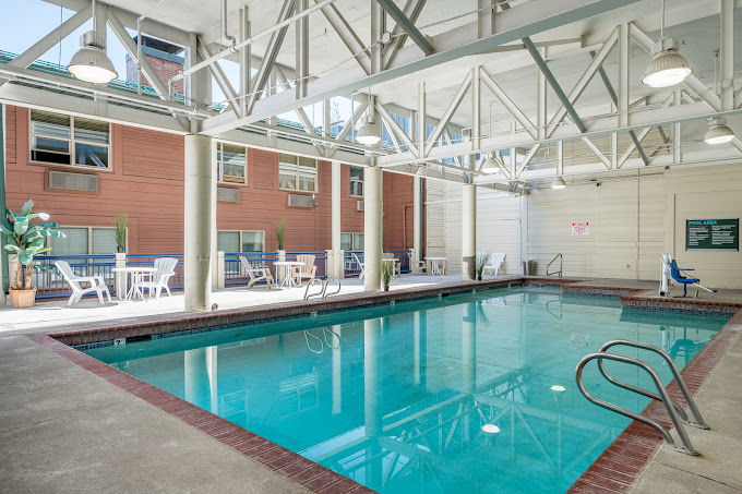 image Dive into relaxation at this indoor pool area, designed to provide a refreshing escape with easy access to sun loungers perfect for unwinding after a day of skiing.