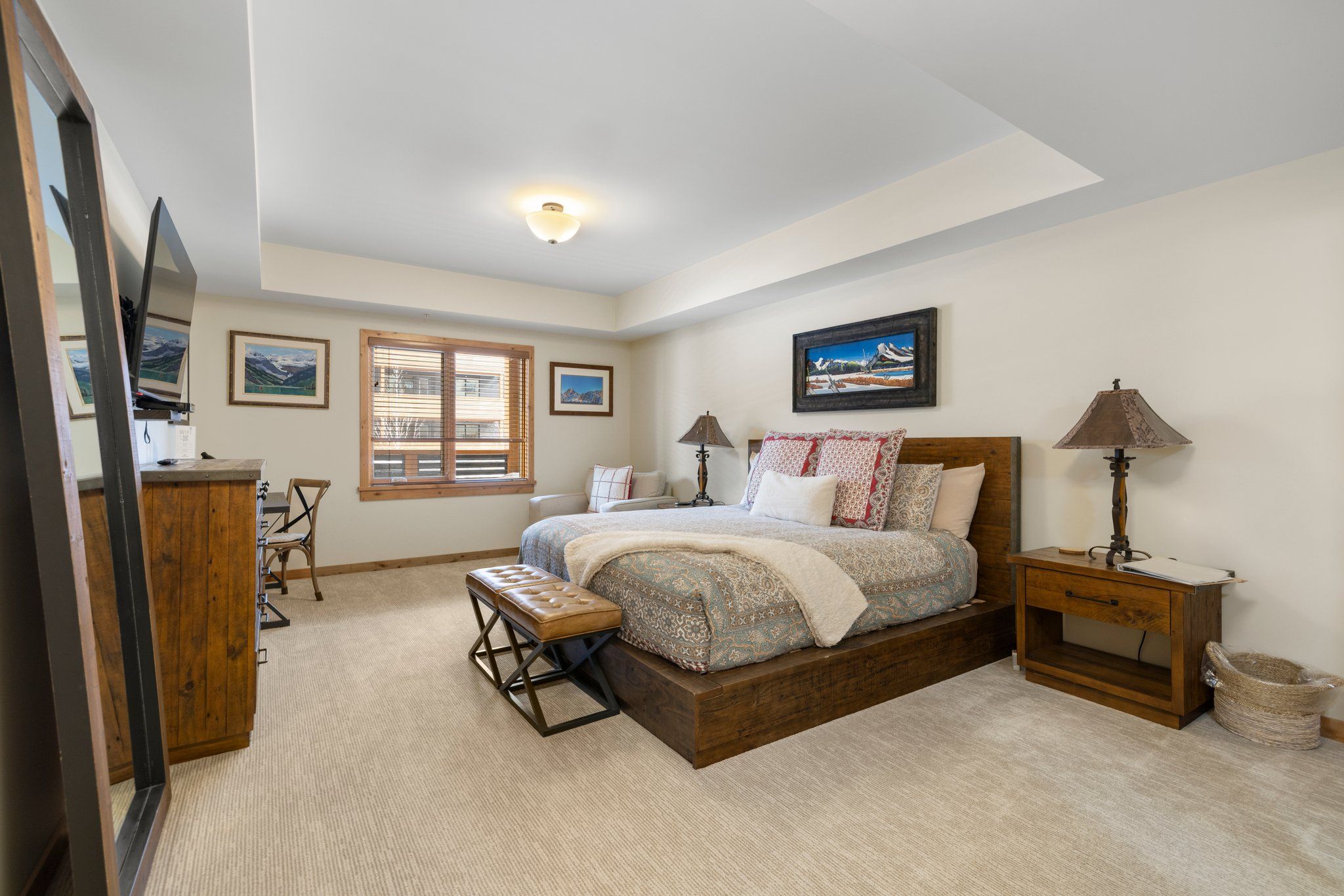 image Serene master bedroom featuring a king bed, warm lighting, and direct access to a spa-style ensuite.