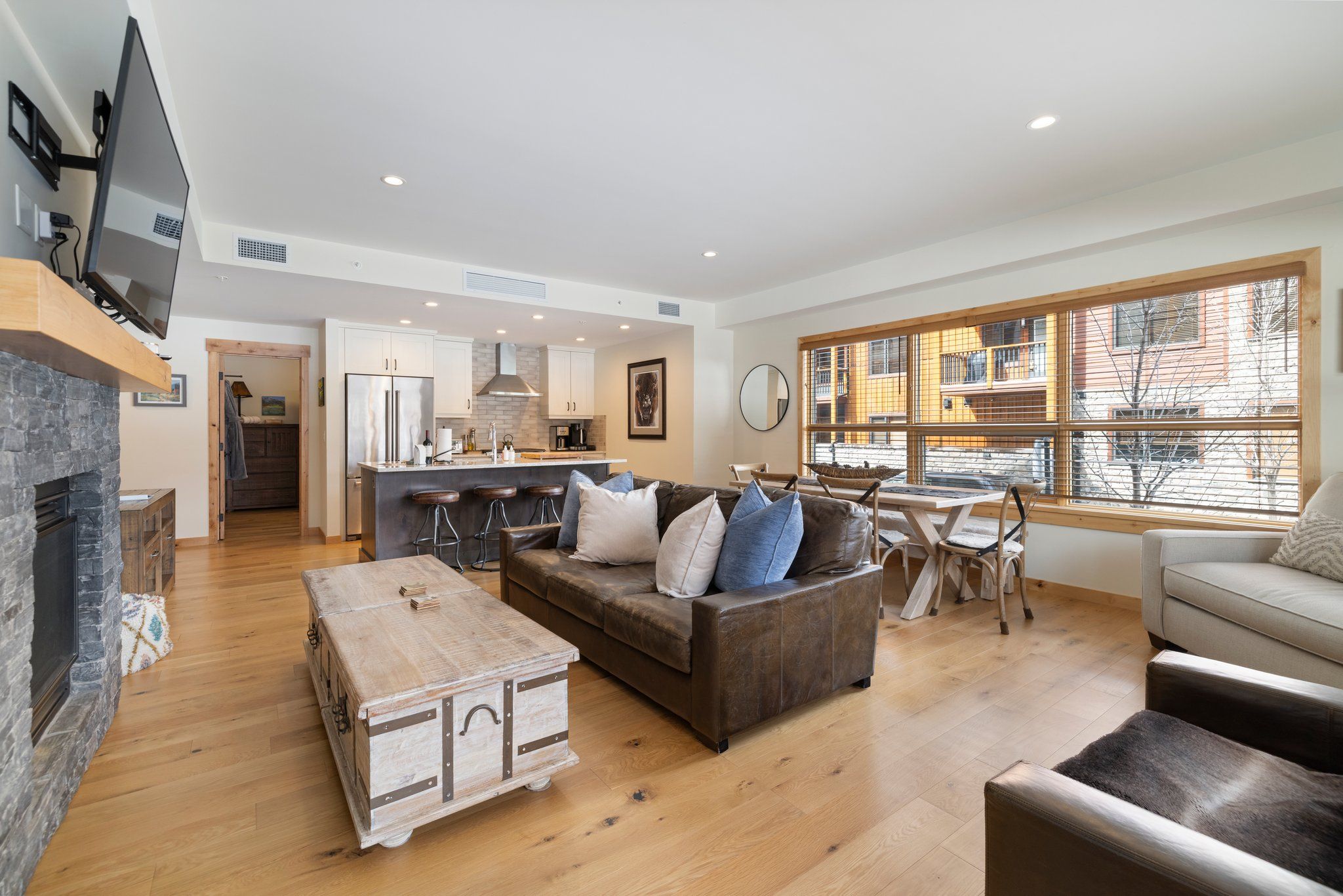 image Spacious open-concept living area with cozy gas fireplace and stylish alpine decor, perfect for relaxing after a day of adventure.