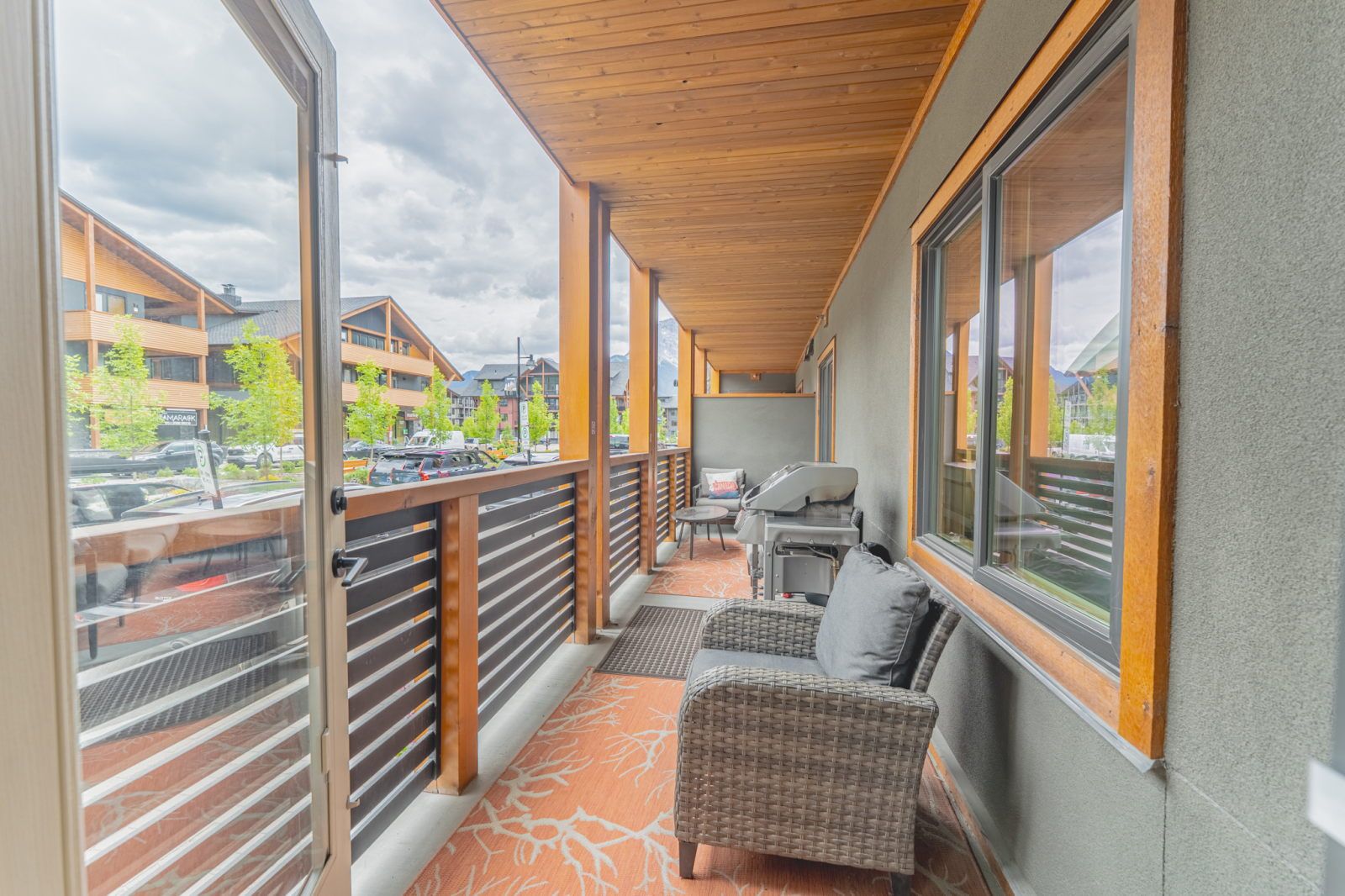 image Covered balcony with wicker furniture and a barbecue grill