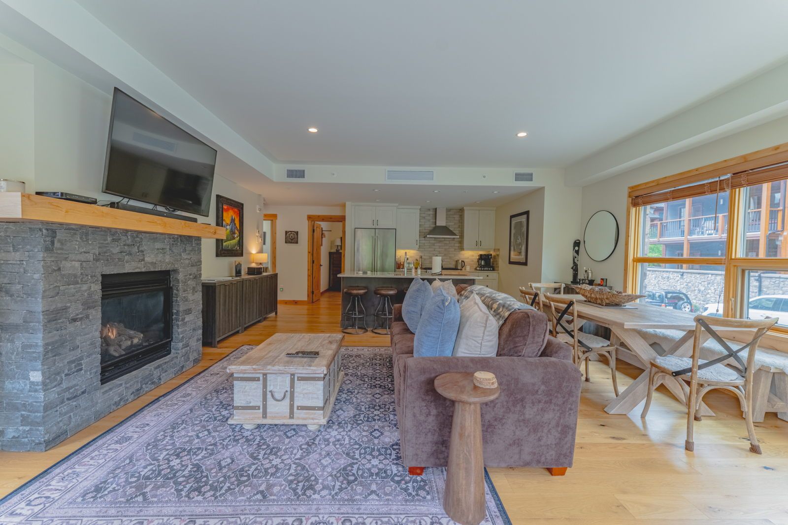 image Living room with fireplace, sofa, and dining area