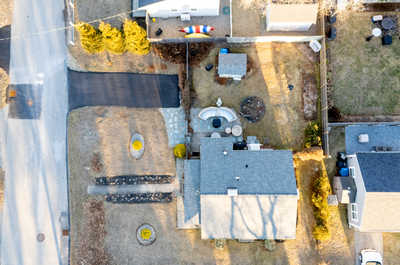 Aerial view showcasing the peaceful neighborhood and the home’s spacious lot.