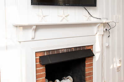 Cozy fireplace with a mounted TV above — enjoy movie nights or quiet evenings by the fire.