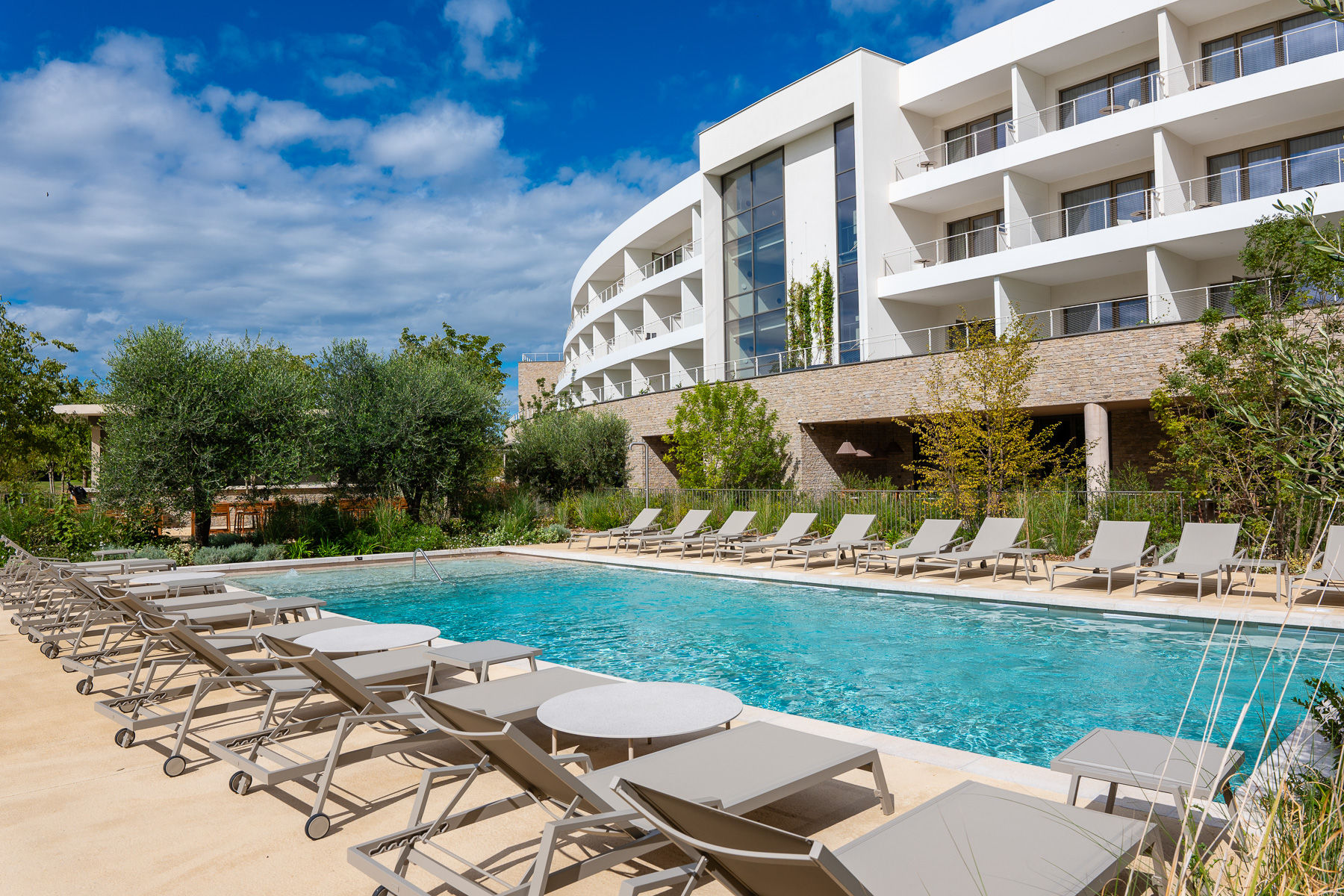 image Unwind poolside with ample loungers and serene views of the Horizon Resort’s elegant modern architecture.
