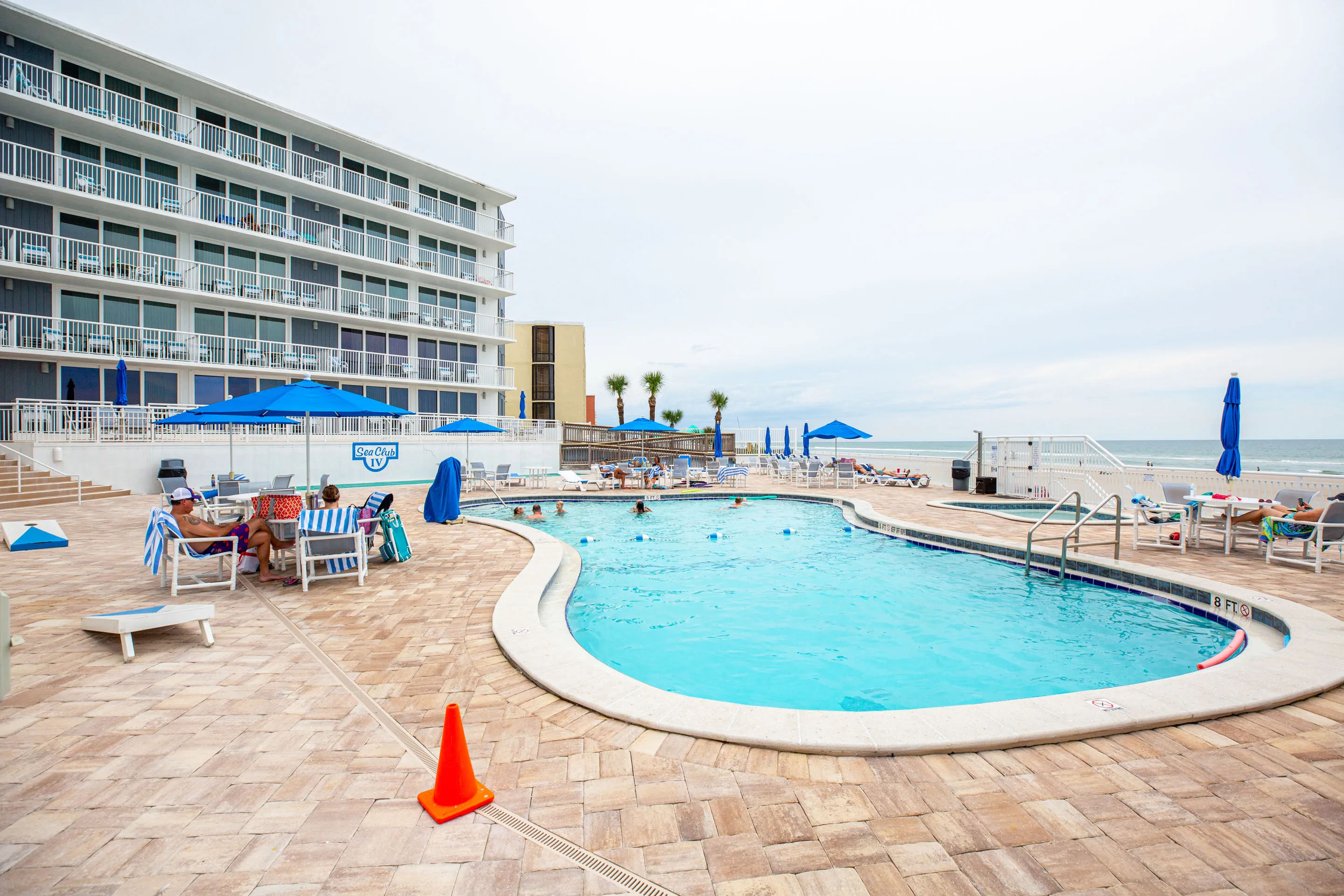 image Relax by the sparkling pool with ocean views, perfect for enjoying a sunny afternoon at Sea Club IV Resort.
