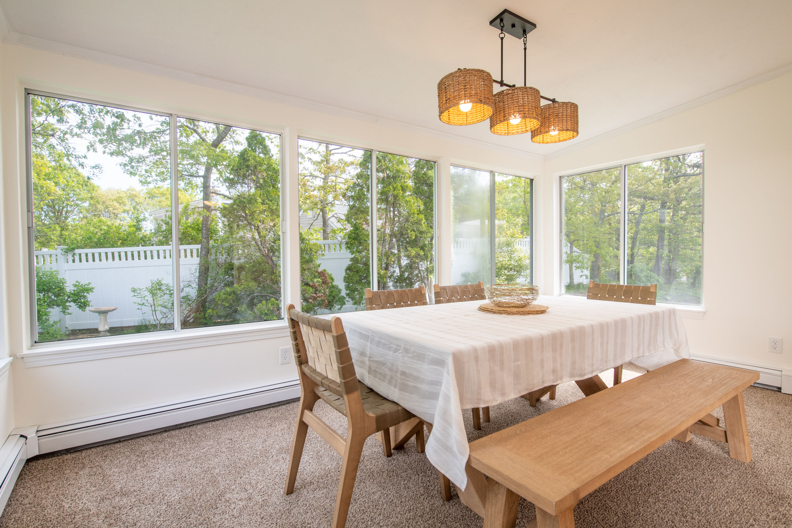 image Sunlit dining room in the cozy sunroom—ideal for casual meals and board games with garden views.