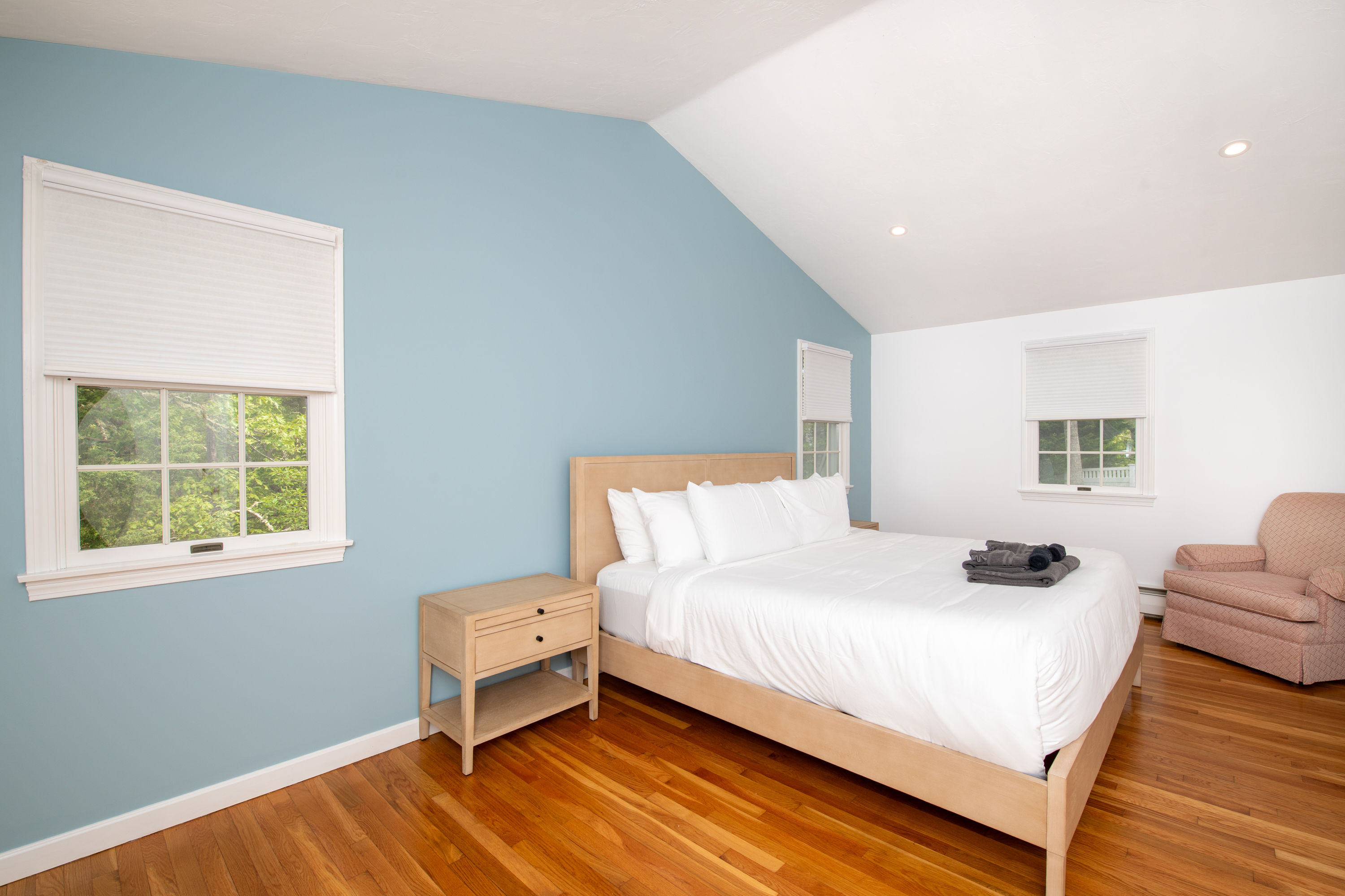 image Primary bedroom with king bed, vaulted ceilings, and natural light—your cozy coastal haven.