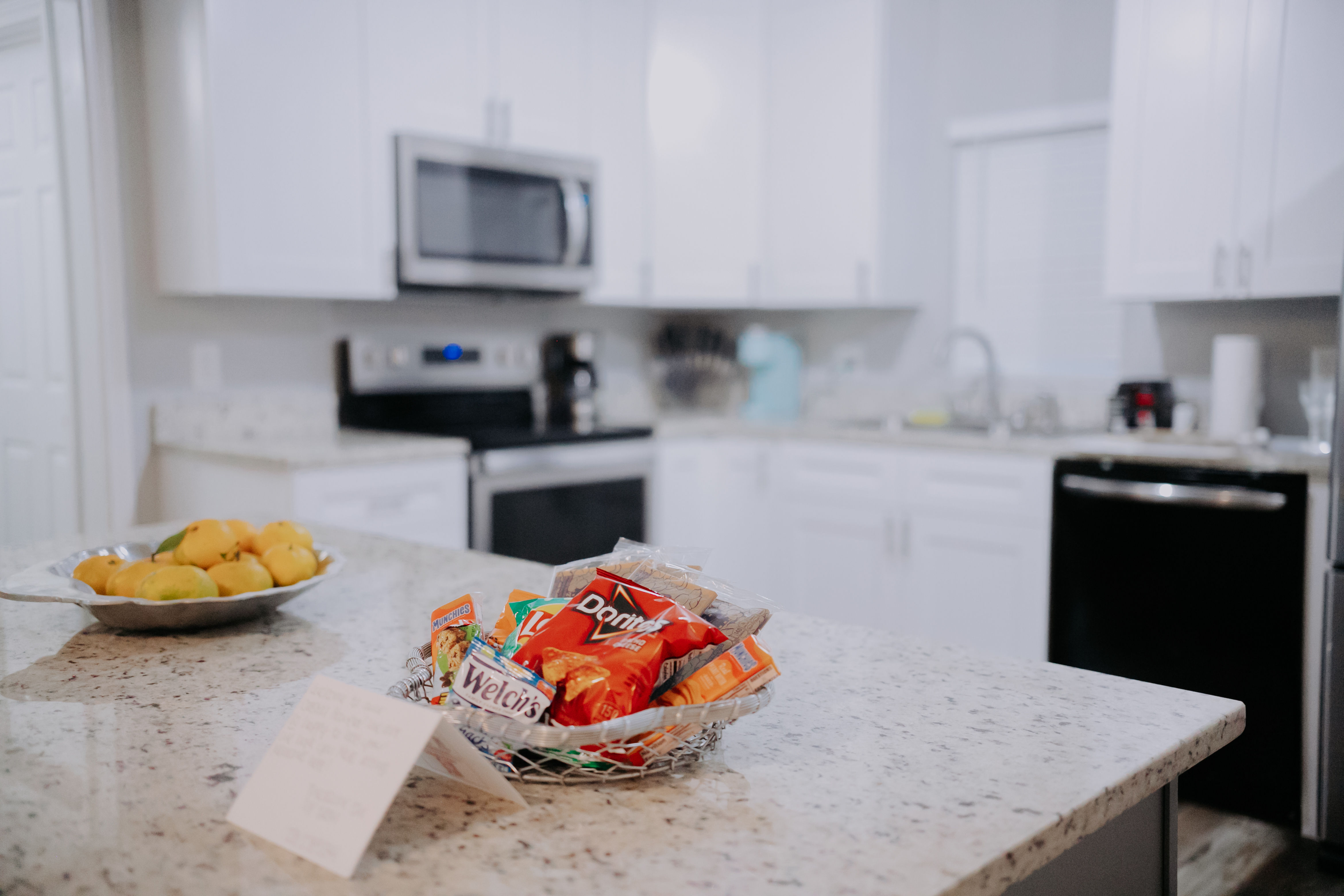 image The spacious kitchen is equipped with modern appliances and snacks, perfect for family gatherings.
