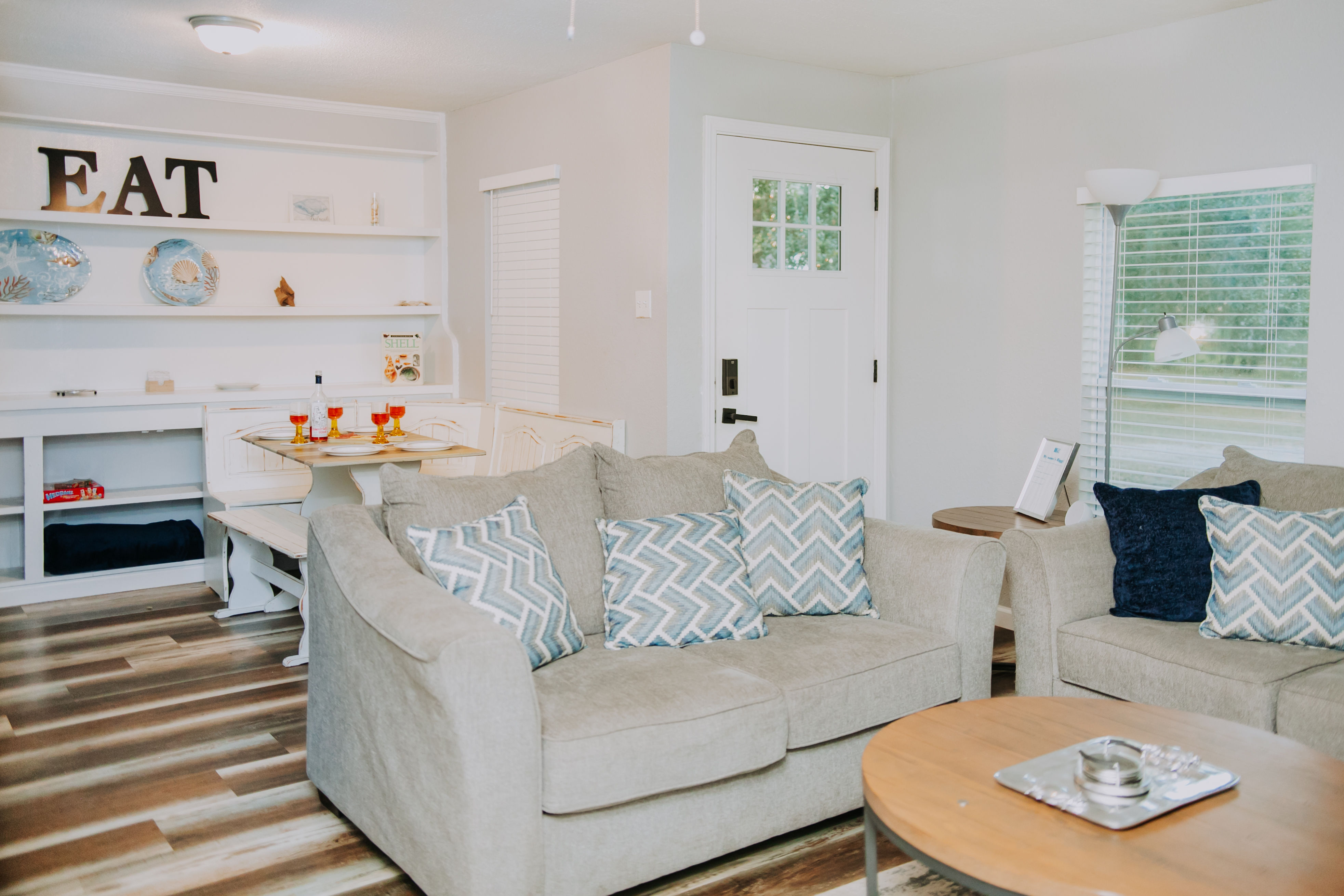 image The inviting living room features cozy seating adorned with decorative pillows, perfect for relaxation after a day at the beach.