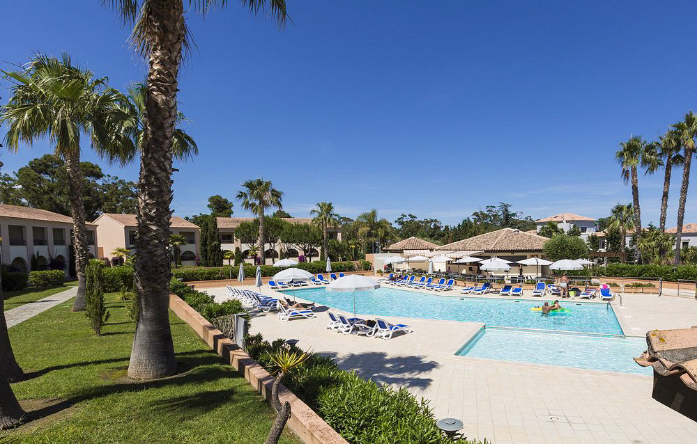 image Sunbathe or unwind by the spacious main pool, perfectly placed for summer days in Linguizzetta.