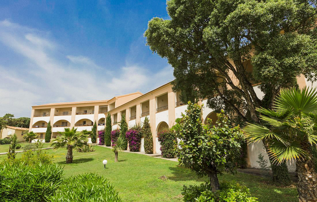 image Mediterranean-style architecture nestled in lush Corsican gardens creates a relaxing, seaside ambiance.