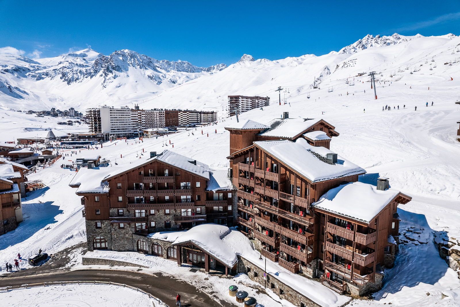 image Ski-in, ski-out convenience with snow-covered slopes and alpine buildings right at your doorstep