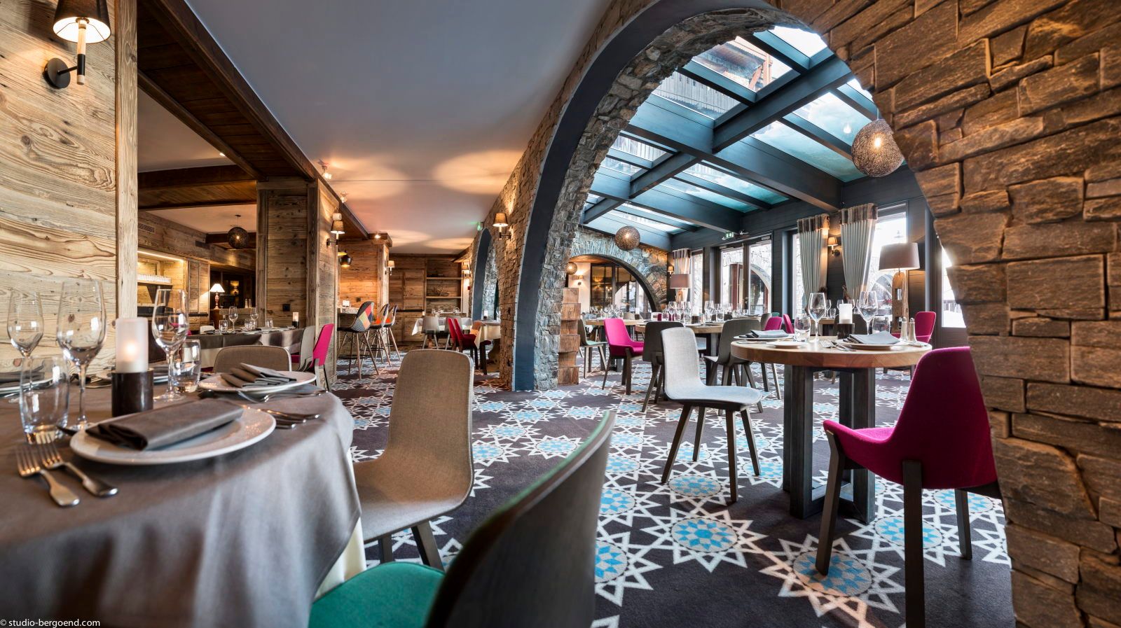image Bright restaurant dining with colourful chairs and a soaring skylight flooding the space with natural light