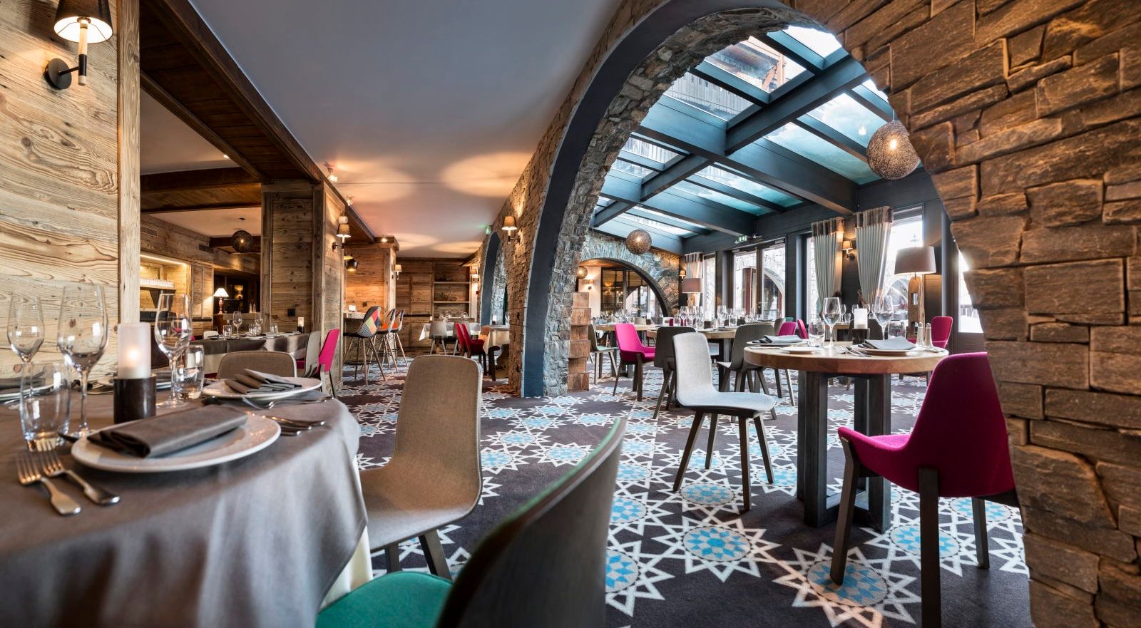 image Bright restaurant dining with colourful chairs and a soaring skylight flooding the space with natural light