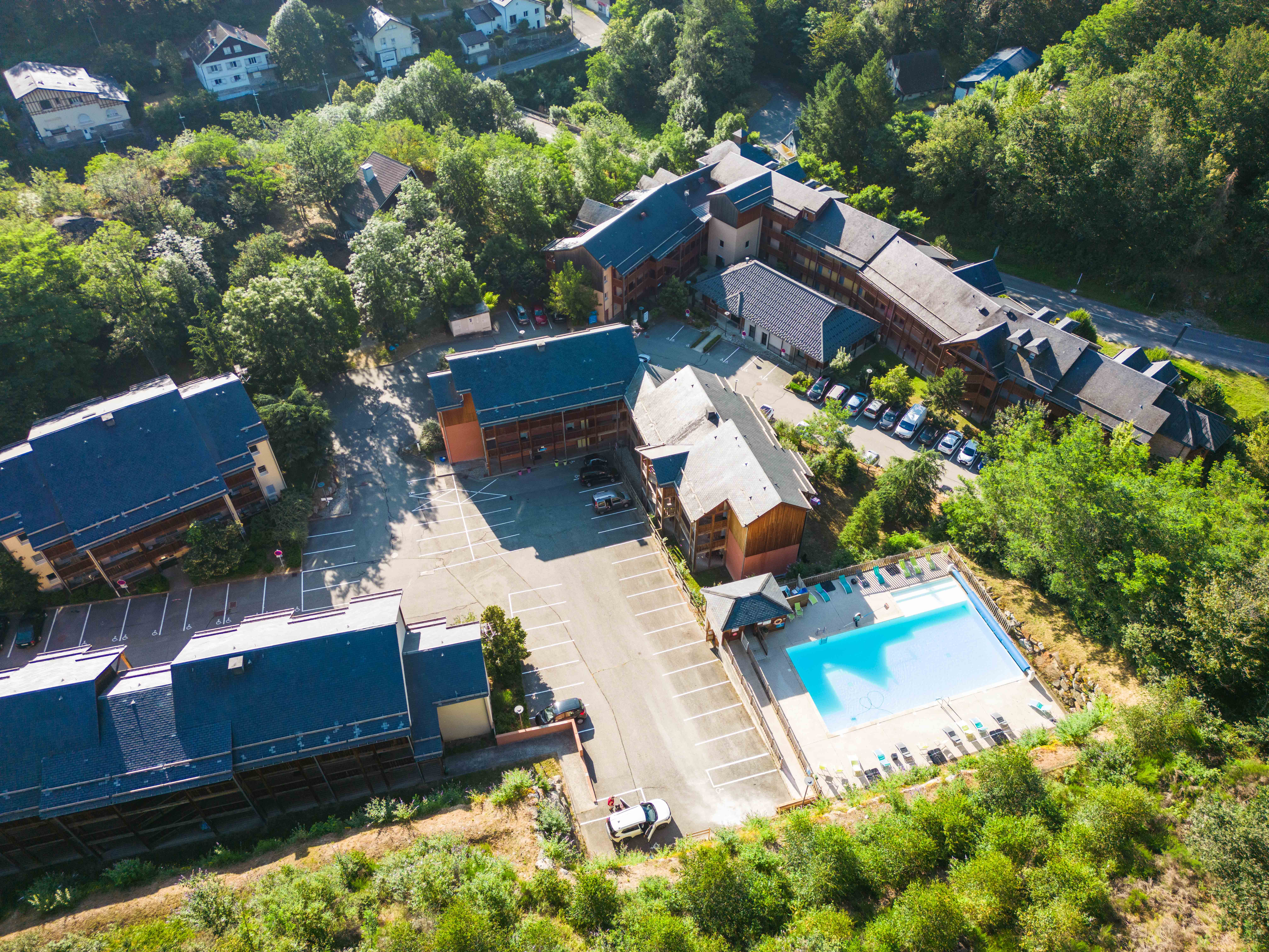 image Bird’s-eye look at the resort layout with private terraces, pool, and vibrant greenery all around.