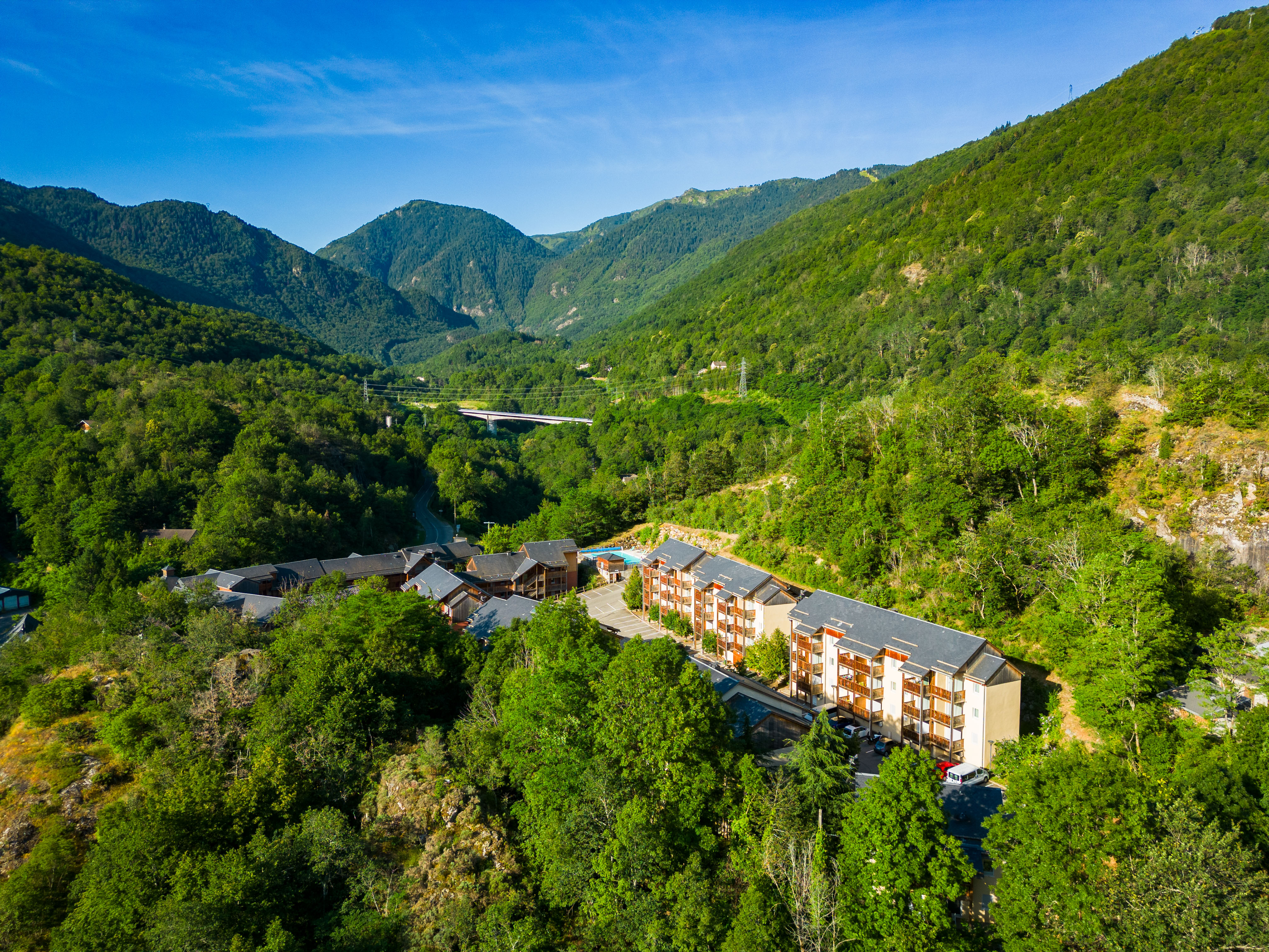 image The residence blends beautifully into the green hillsides of the Ariège region.
