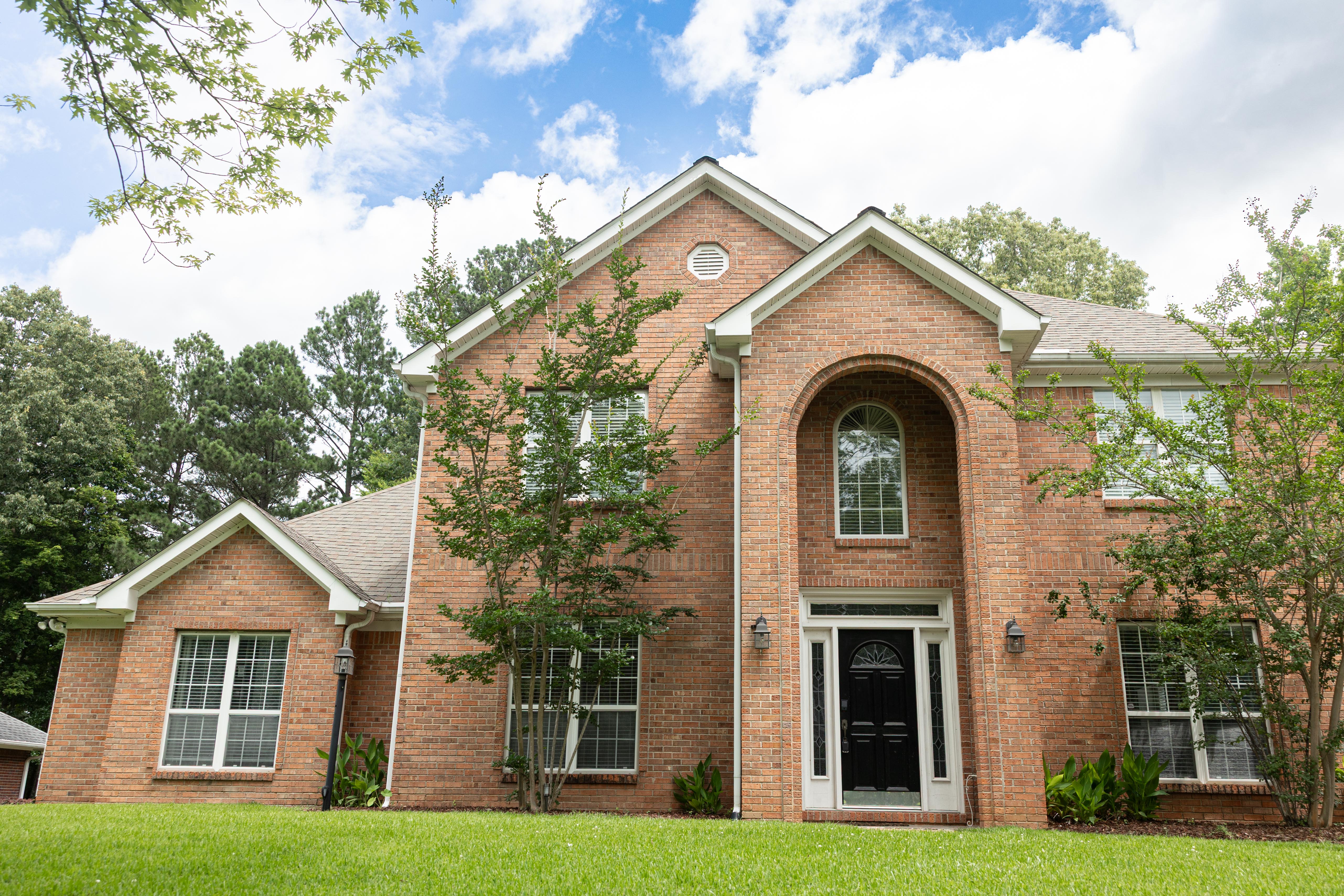 image This stunning two-story brick home in Starkville's Sherwood Forest boasts beautiful landscaping and classic architectural details.