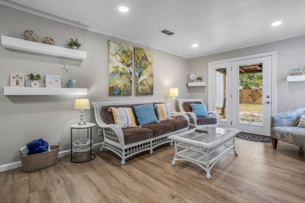 image Relax in the inviting living room, adorned with comfortable wicker furniture and cheerful decor, ideal for unwinding after a day of sun and surf.