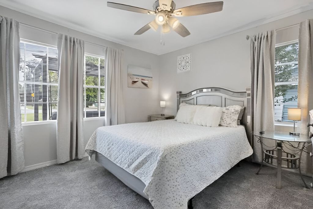 image The serene bedroom boasts natural light and soft, calming decor, providing a peaceful retreat to recharge after sun-soaked adventures.