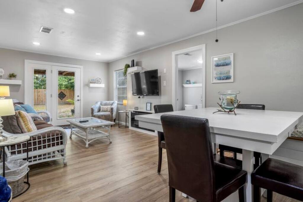image The cozy living area invites you to unwind with smart TVs and plenty of seating, ideal for family gatherings after a day at the beach.