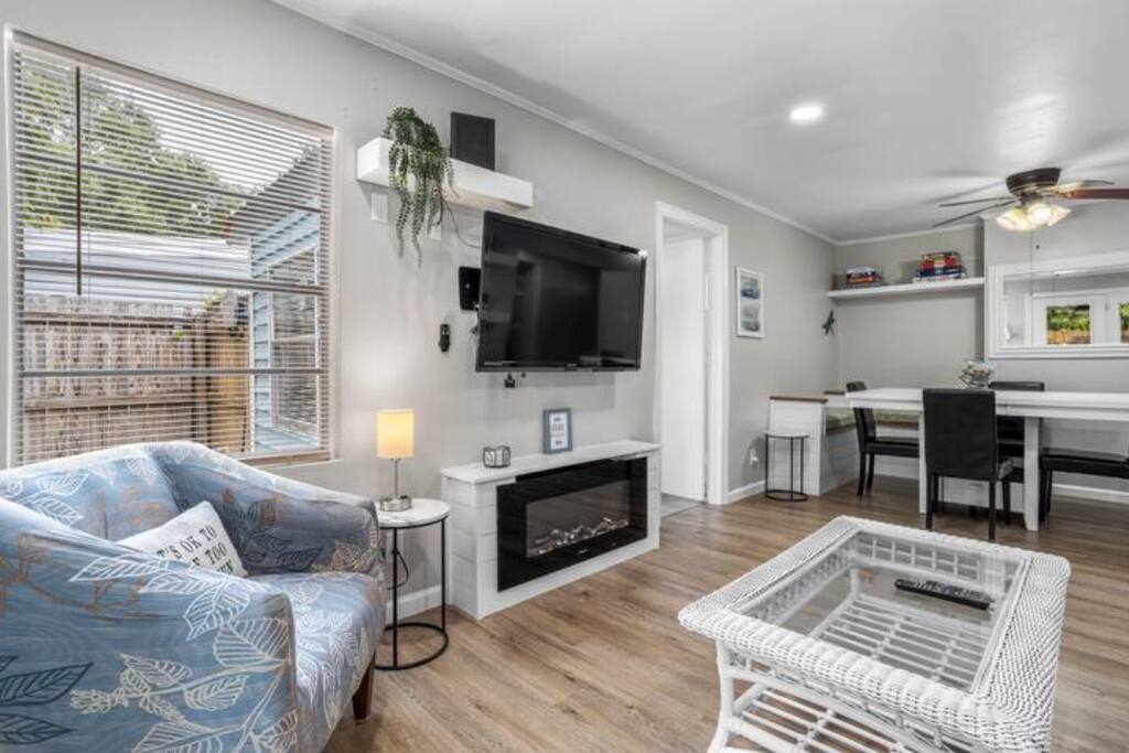 image Enjoy movie nights in the modern living room featuring a sleek TV setup and an electric fireplace, enhancing coziness during cooler evenings.