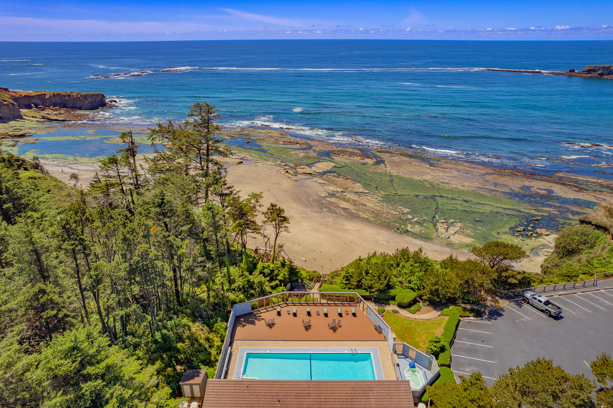 image With picturesque views of the sandy beach and rocky shoreline, the pool area offers a relaxing retreat in a scenic natural setting.