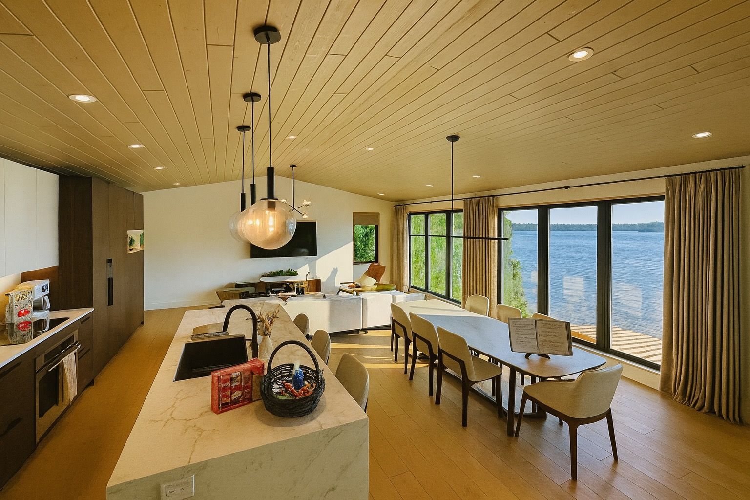 image Spacious dining area beside the chef’s kitchen, offering sweeping lake views through sliding glass doors.