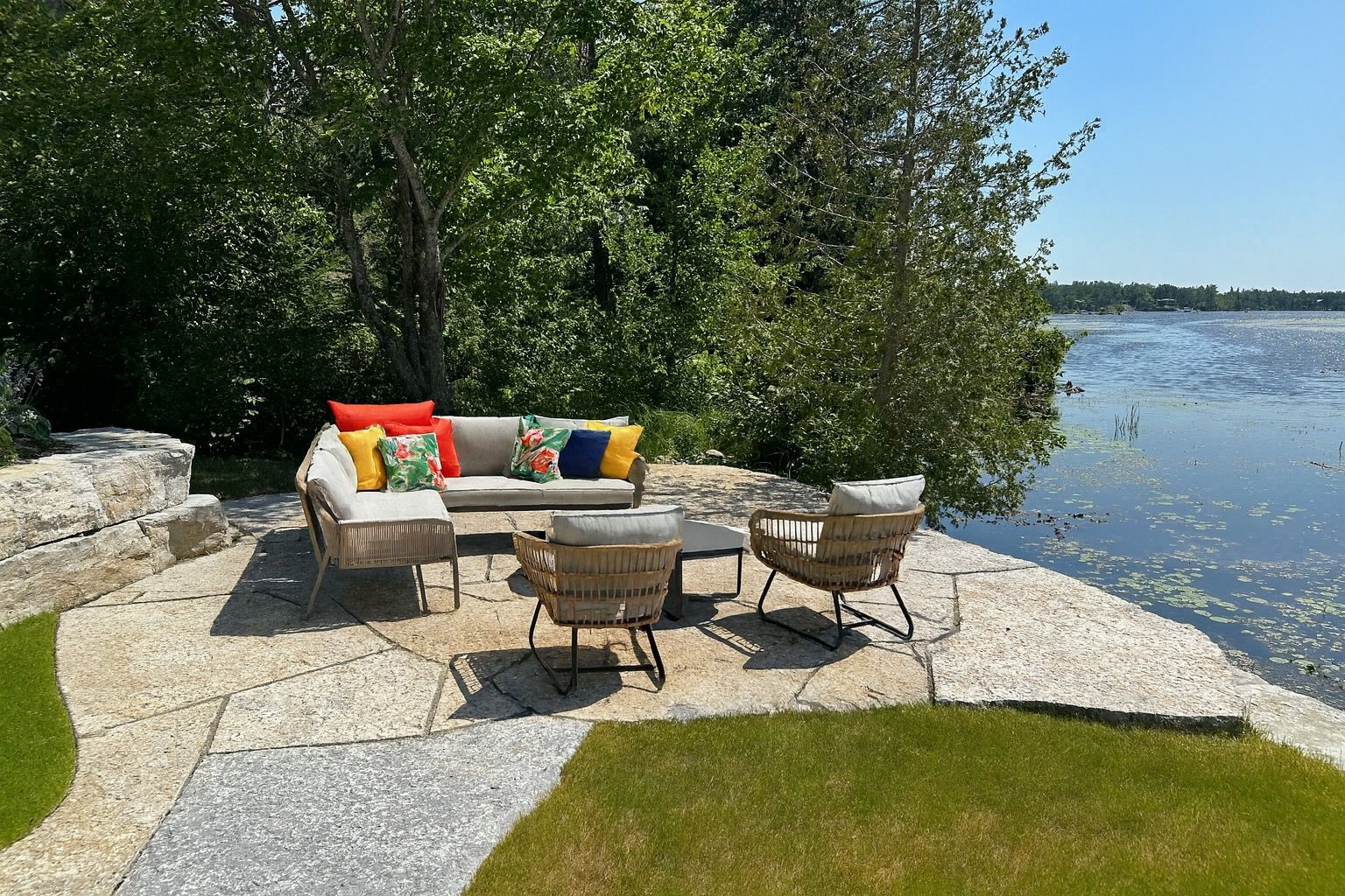 image Stone patio tucked beside the lake, with cozy seating for relaxing lounging just steps from the water.