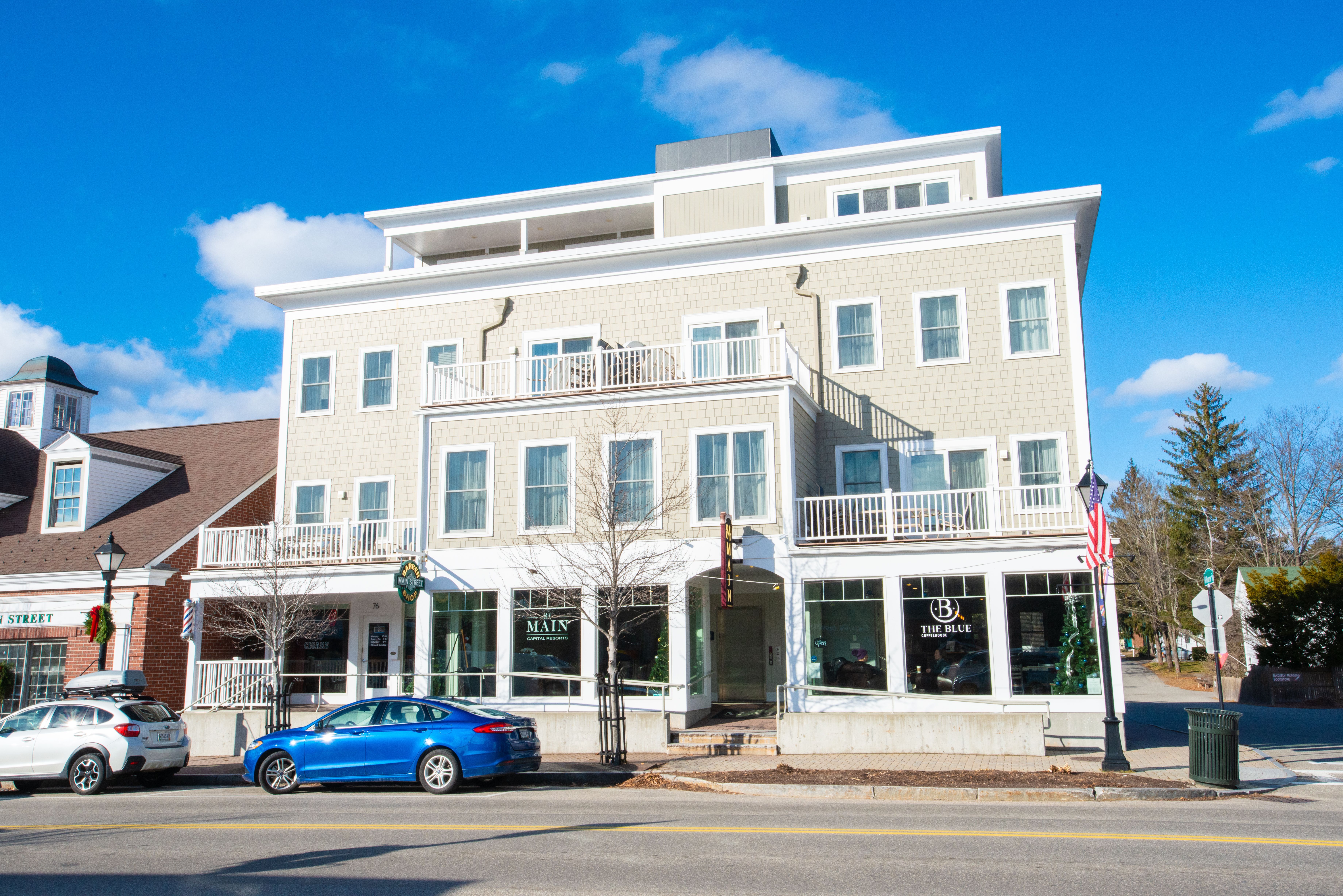 image Bathed in bright sunlight, the stylish facade showcases its modern elegance amidst the timeless coastal culture of Kennebunk.
