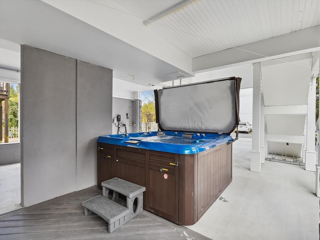 image Relaxing hot tub under a covered patio, offering year-round comfort after days on the beach.