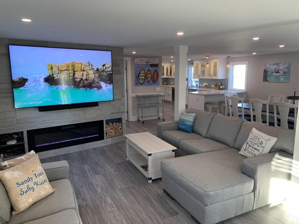 image Spacious living area with sectional seating, fireplace, and large-screen TV—perfect for movie nights and gatherings.