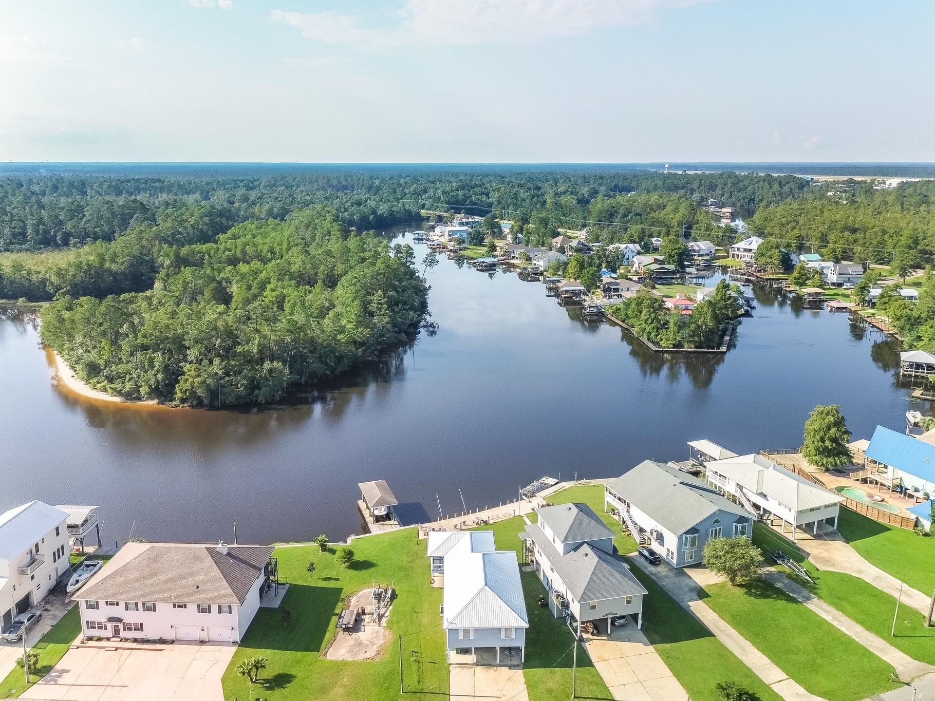image Captivating vista of the winding river, surrounded by scenic beauty and cozy homes, perfect for family gatherings.