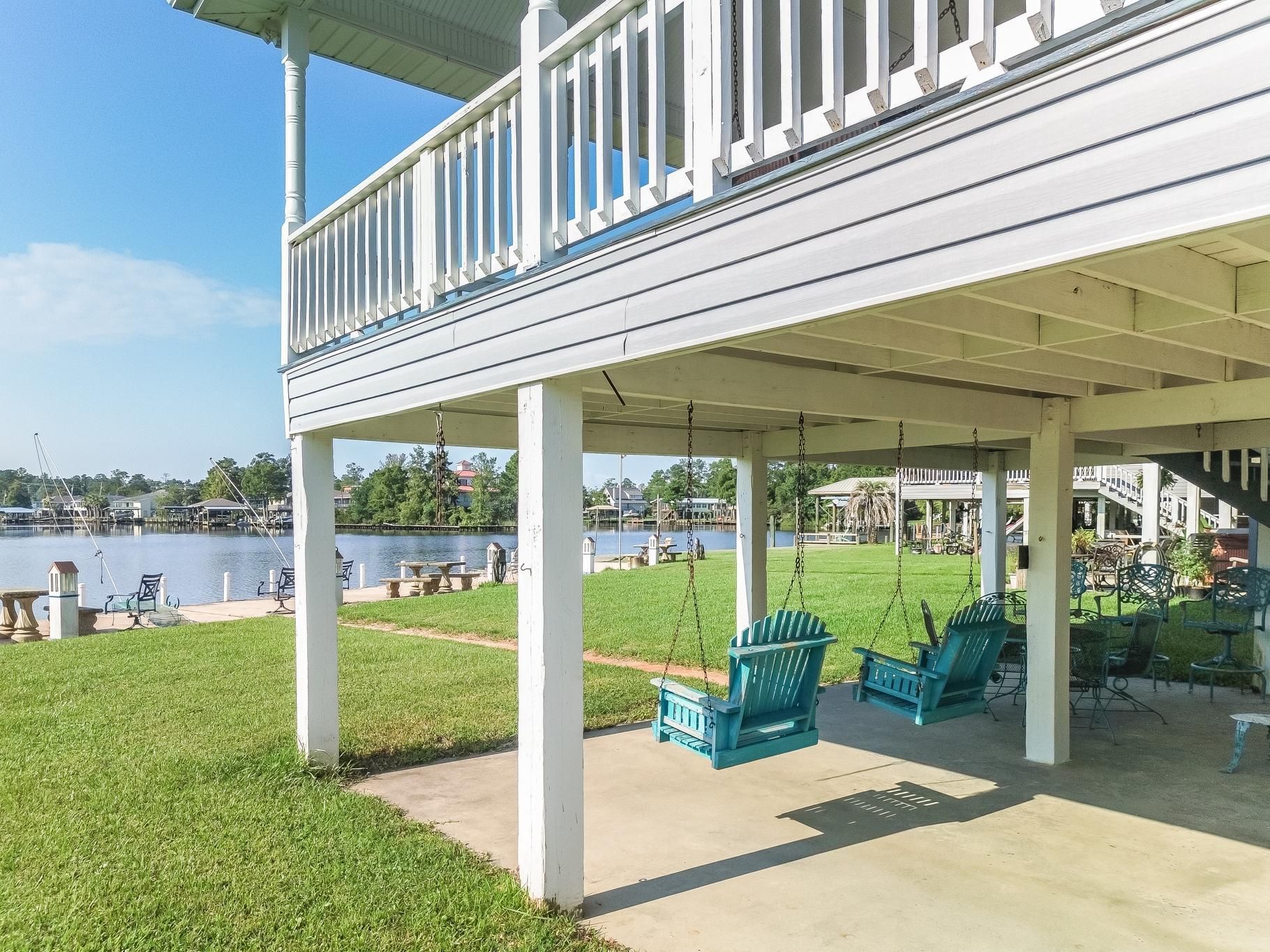 image Enjoy beautiful views of the river from the comfortable swings located beneath the house, inviting moments of tranquility.