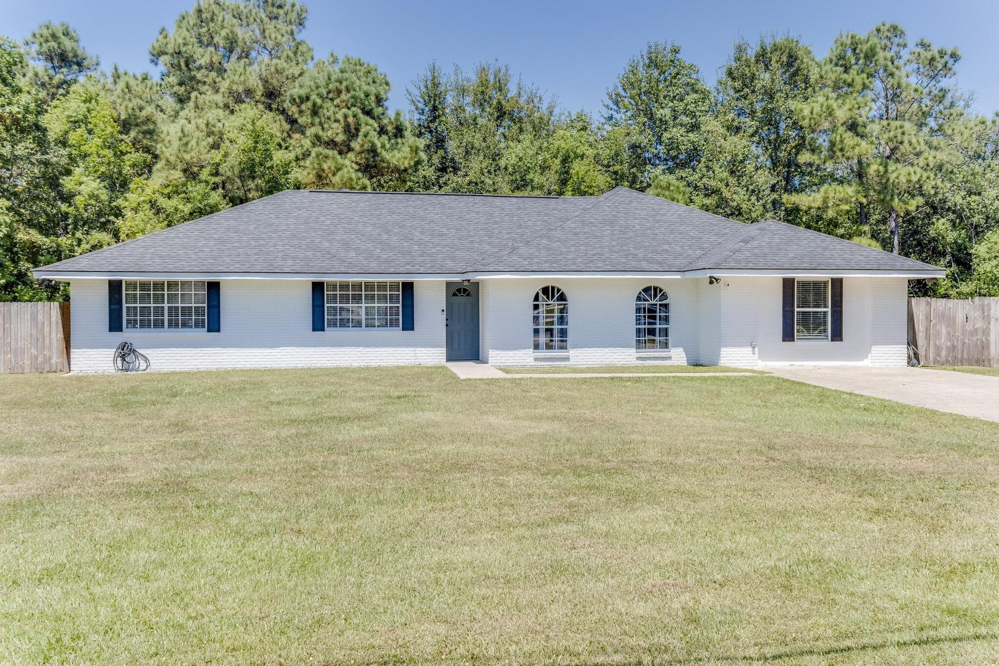 image Charming single-level home with a large front lawn and easy access to nearby beaches and activities.