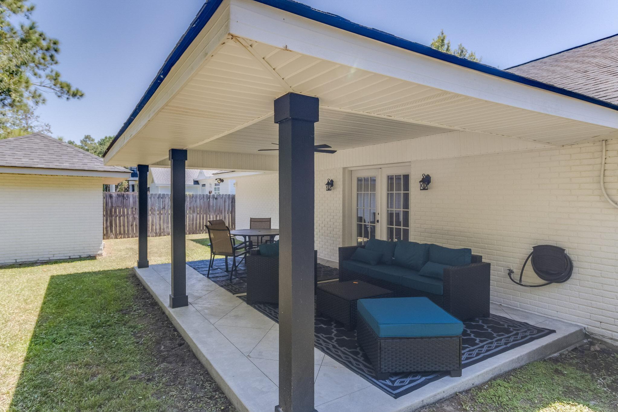 image Covered back porch with outdoor seating—ideal for morning coffee or relaxing in the shade.