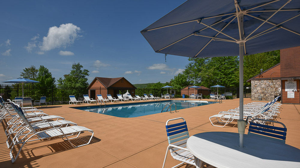 image Relax poolside under sunny skies at Swiss Mountain’s community outdoor pool.