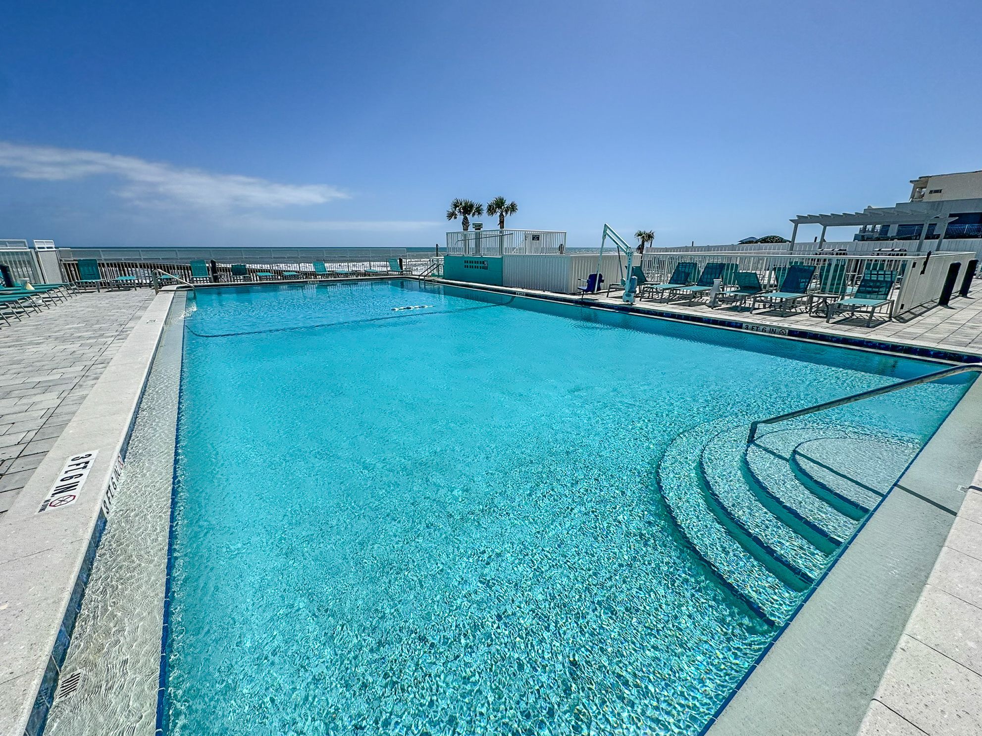 image Dive into the pristine pool that blends seamlessly with ocean views, providing a perfect setting for relaxation and fun.