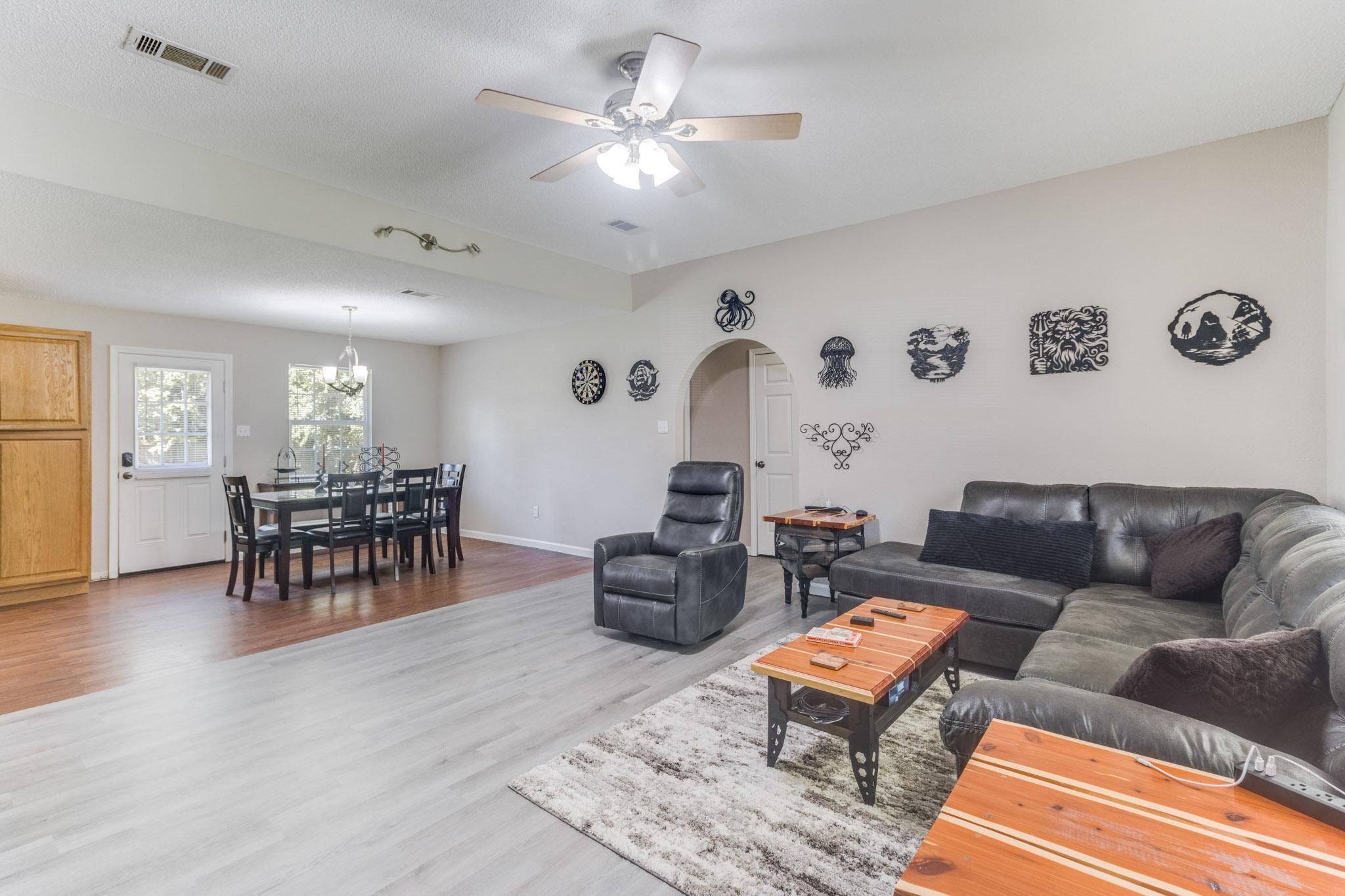 image Gather in the spacious living room with sectional seating, sleek flooring, and bright natural light.