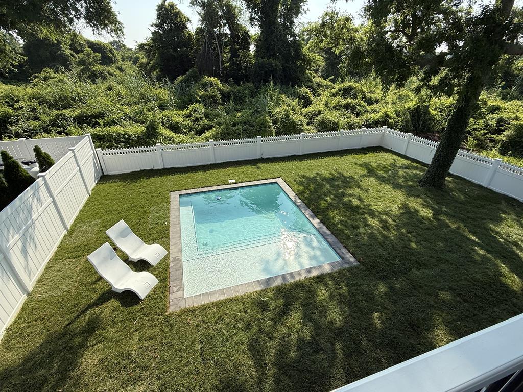 image Enjoy the heated saltwater pool surrounded by lush greenery—your private backyard oasis.