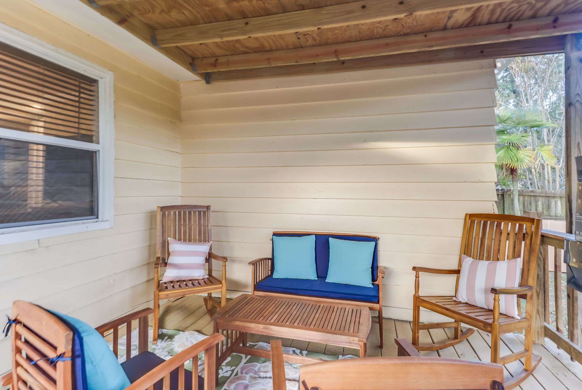 image A cozy outdoor porch retreat is perfect for relaxing with friends, showcasing comfortable seating and a tranquil ambiance.